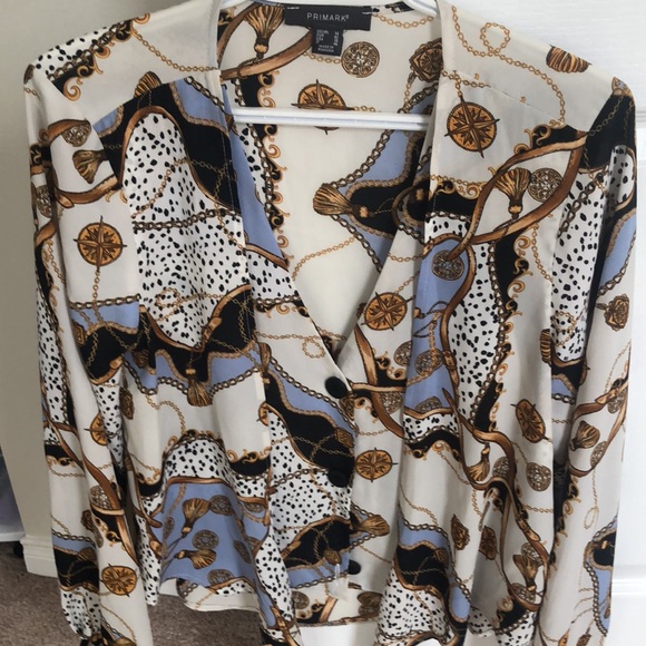 A really pretty blouse It buttons up and then wraps across. - Picture 2 of 2